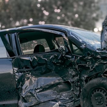 Crashed,Black,Car,After,Serious,Accident,On,The,Road.,Concept